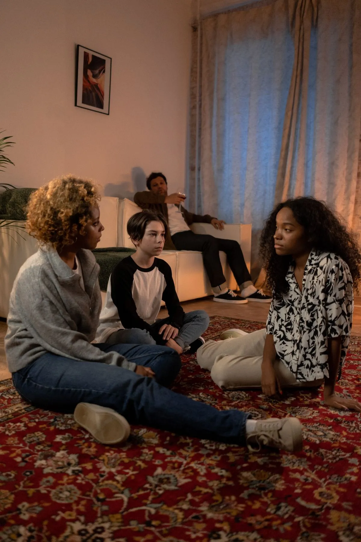 A family sitting together in their living room, talking